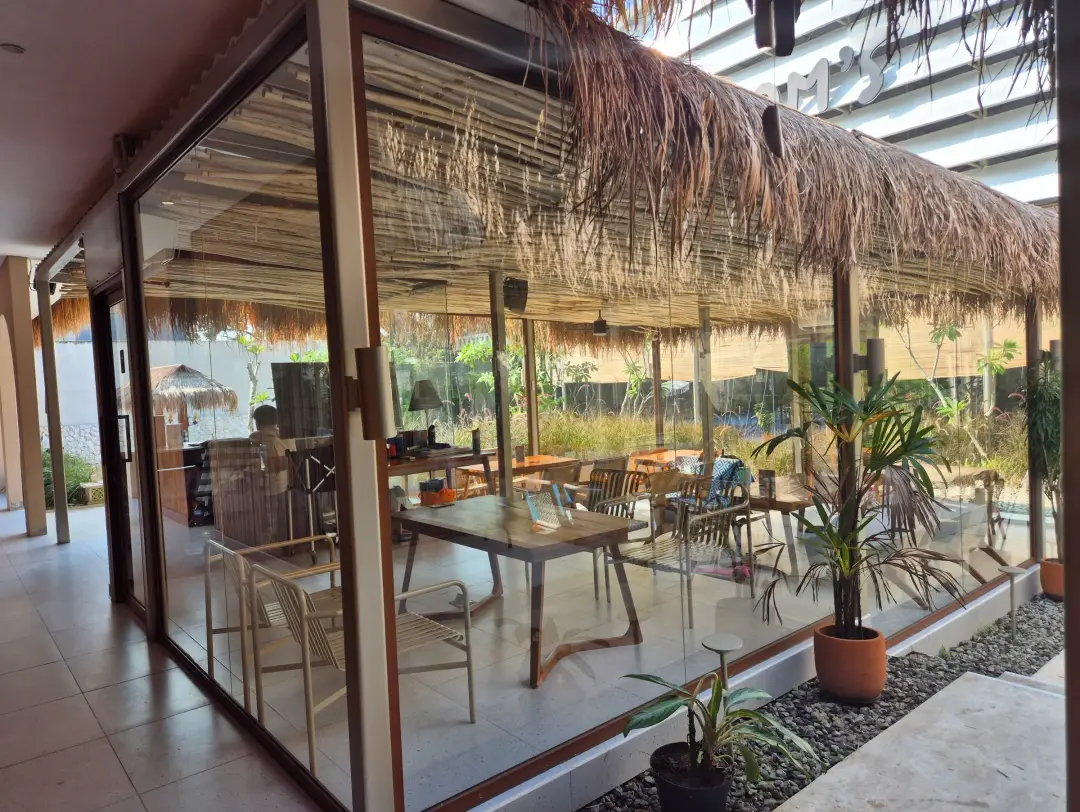 Glass-walled lounge under thatch