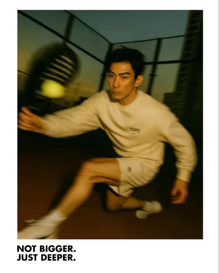 A player lunging for a volley, motion-blurred
