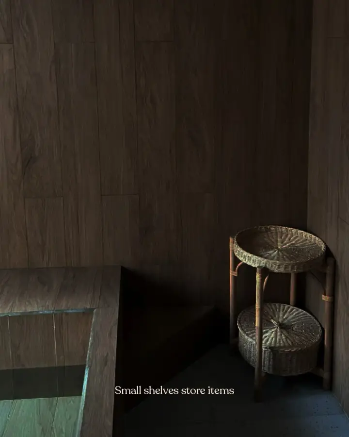 Timber cold plunge room with a rattan side table